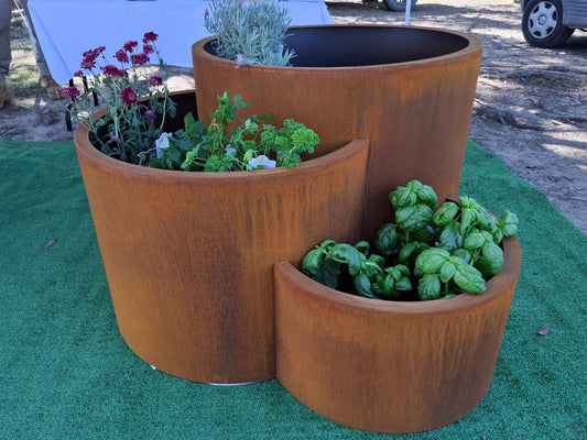 Handcrafted 3 Tier Corten steel planter with folded lip, vertical design for herbs and flowers, displayed outdoors on a patio