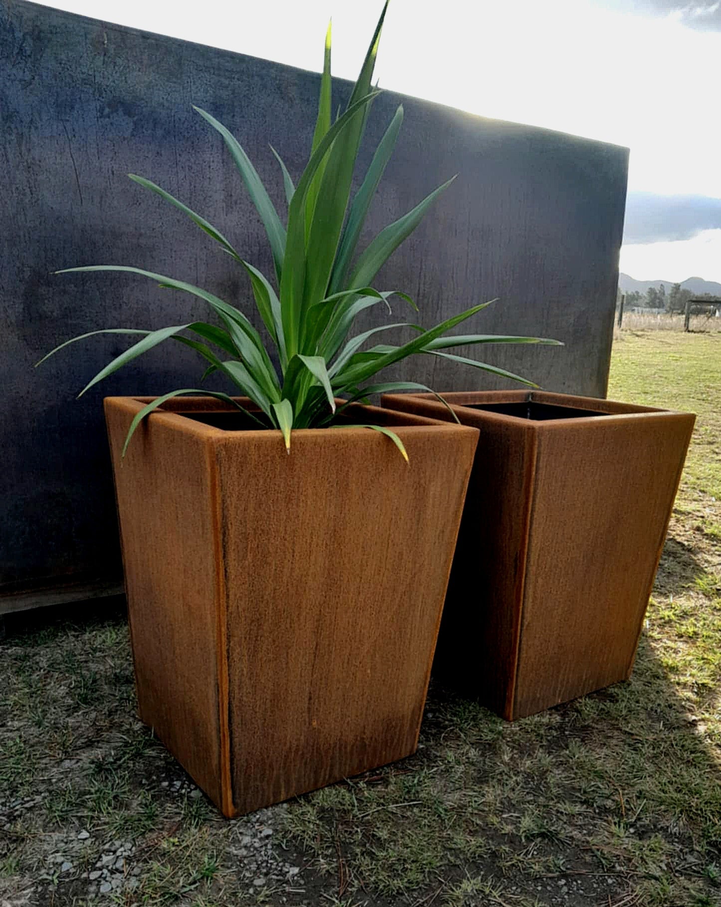Handcrafted tapered Corten steel planter with a clean modern silhouette, ideal for patios, decks, or entryways