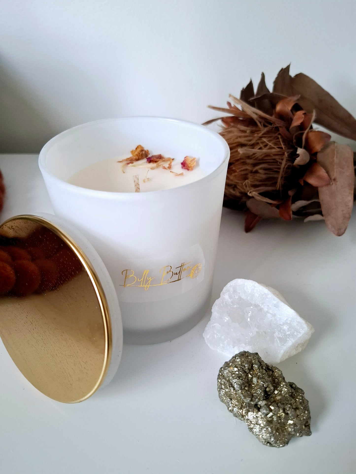 375ml soy wax candle with single cotton wick, topped with dried rose petals and pebble crystals – natural, handcrafted design