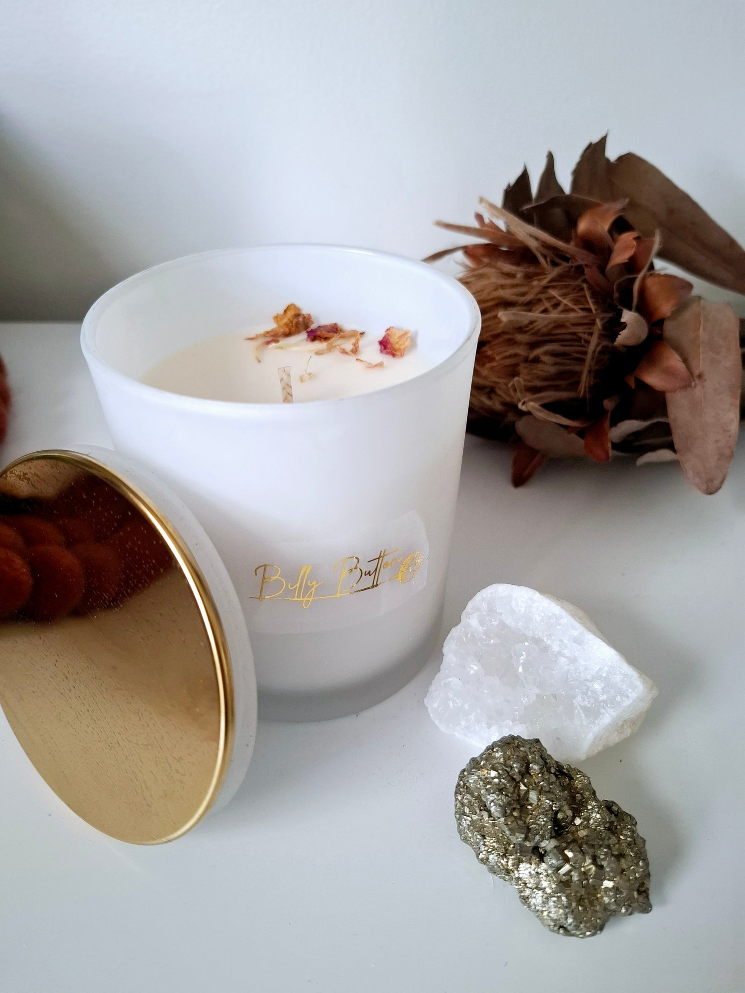 375ml soy wax candle with single cotton wick, topped with dried rose petals and pebble crystals – natural, handcrafted design